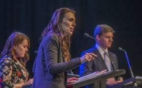 Jacinda Ardern, centre, and Bill English, right, in the third leaders debate.