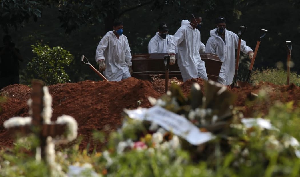 Cemetery workers carry the coffin of a victim of COVID-19 at the Vila Formosa cemetery in Sao Paulo, Brazil, on March 23, 2021. - Brazil's daily Covid-19 death toll soared past 3,000 for the first time