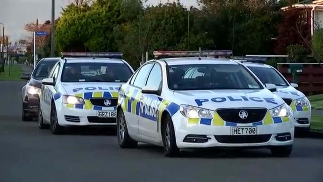 Police leave the scene, having arrested a man after a two-day manhunt.