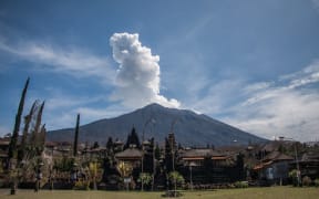 INDONESIA, Bali: Mount Agung volcano spews ash into the sky as seen from Besakih temple  in Karangasem in Bali, Indonesia on December 7, 2017. Tens of thousands of Balinese villagers living in small communities that ring Mount Agung have fled to evacuation centres - Muhammad Fauzy Chaniago