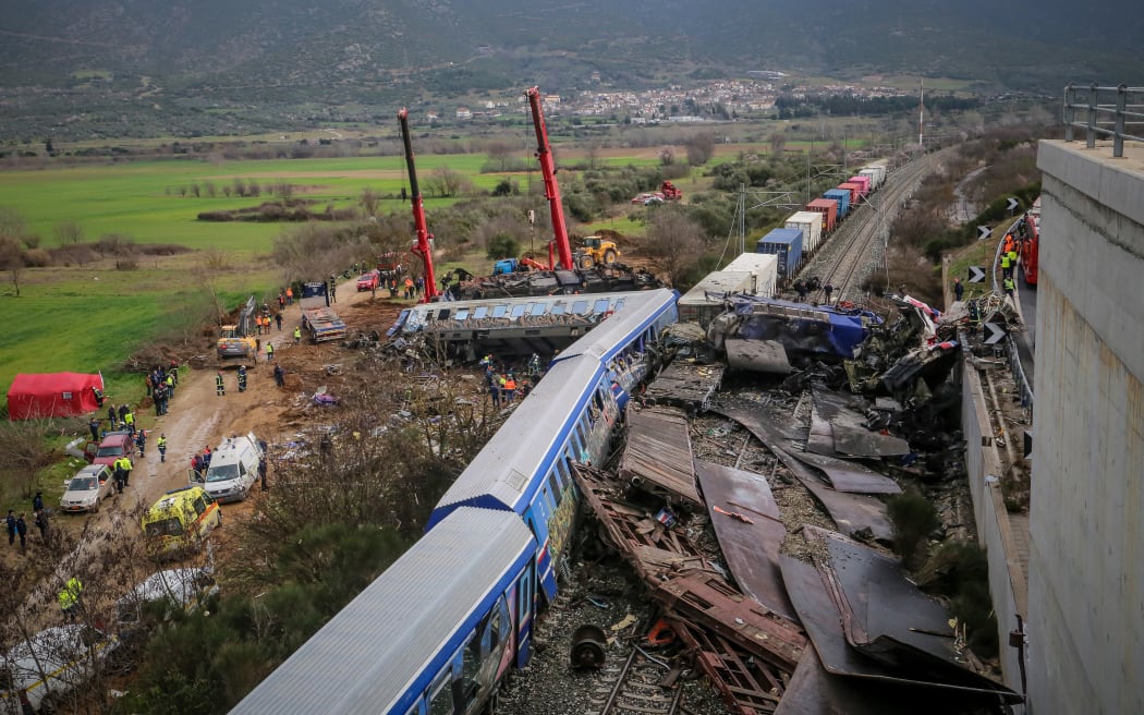 Police and emergency crews search the debris of a crushed wagon after a train accident in the Tempi Valley near Larissa, Greece on 1 March 2023. - At least 36 people were killed after a collision between two trains caused a derailment near the Greek city of Larissa late at night on February 28, 2023, authorities said.