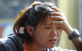 A relative of one of the Sherpas grieves as bodies arrive at a monastery after the avalanche.
