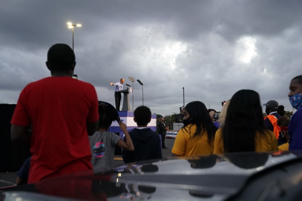 Biden-Harris supporters listen as former US President Barack Obama speaks during a drive-in rally in Philadelphia, Pennsylvania on October 21, 2020. -