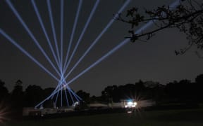 Lights shooting into the sky from the Stardome building.