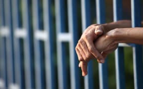 prison generic, hands in prison cell