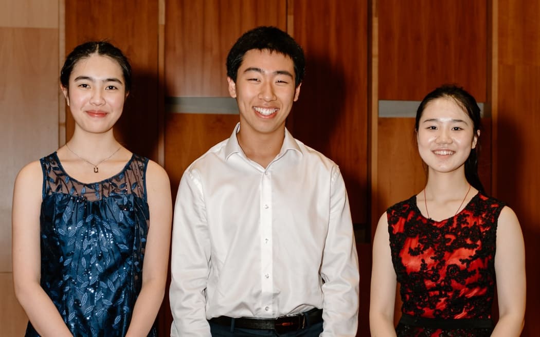 The three young pianists who are the finalists in the National Concerto Competition 2023,  Madeleine Xiao, Henry Meng, and Yuzhang Wu (all from Auckland).