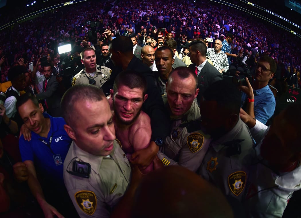 Khabib Nurmagomedov of Russia is escorted out of the arena after defeating Conor McGregor.