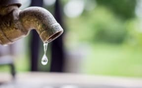 Garden tap leaking, dripping, water.