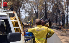 This photo taken on January 8, 2020 shows firefighters in Batlow, in Australia's New South Wales state. -