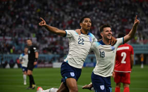 England’s Jude Bellingham reacts with Mason Mount after scoring an opener during the World Cup Group B match at Khalifa International Stadium in Doha on November 21, 2022.