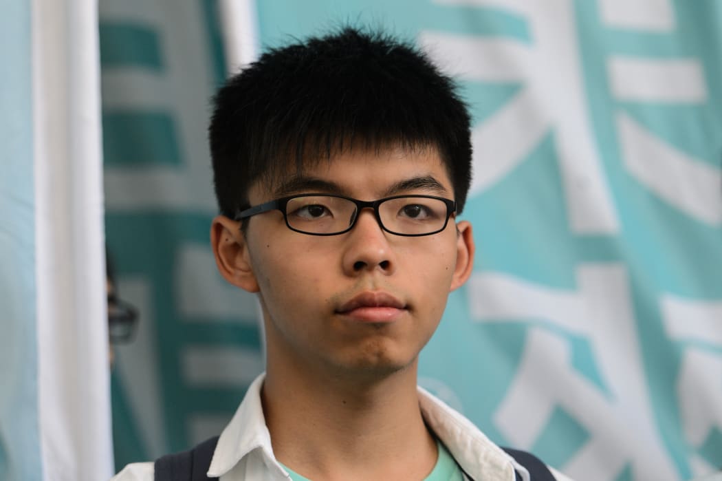 Pro-democracy political activist and member of the Demosisto party Joshua Wong looks on after leaving the Eastern Court in Hong Kong on July 21, 2016.