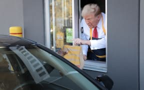 FEASTERVILLE-TREVOSE, PENNSYLVANIA - OCTOBER 20: Republican presidential nominee, former U.S. President Donald Trump works the drive-through line as he visits a McDonald's restaurant on October 20, 2024 in Feasterville-Trevose, Pennsylvania. Trump is campaigning the entire day in the state of Pennsylvania. Trump and Democratic presidential nominee Vice President Kamala Harris continue to campaign in battleground swing states ahead of the November 5th election.   Win McNamee/Getty Images/AFP (Photo by WIN MCNAMEE / GETTY IMAGES NORTH AMERICA / Getty Images via AFP)