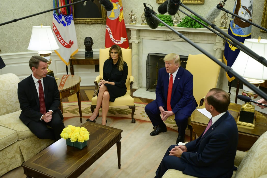 Donald Trump flanked by acting Commissioner of Food and Drug (FDA) Norman Sharpless, left Melania Trump, and US Secretary of Health and Human Services (HHS) Alex Azar.