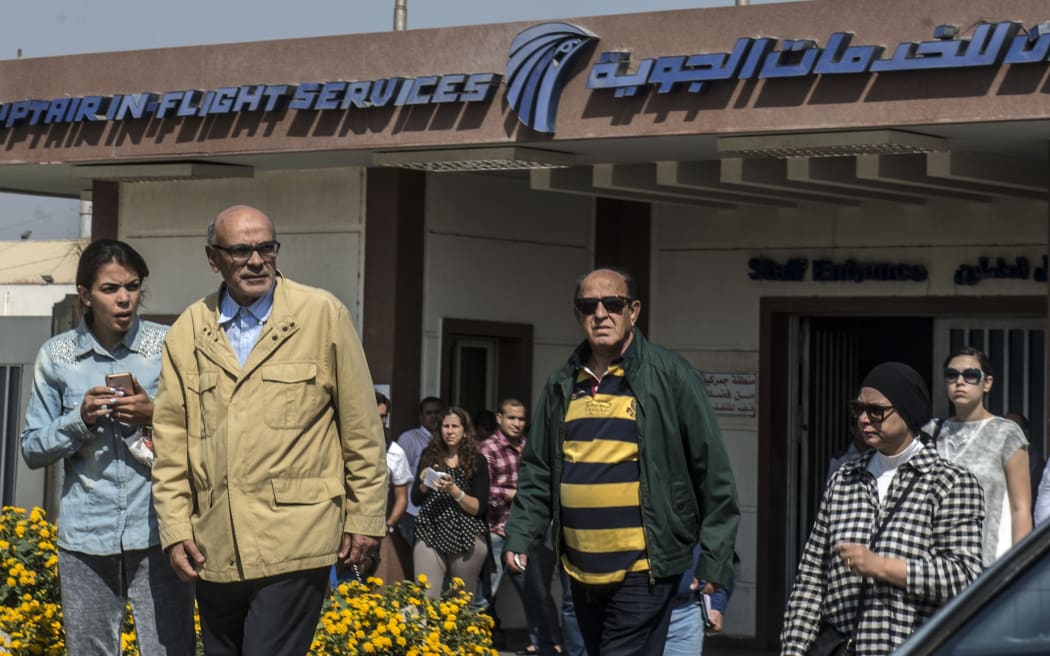 Relatives of passengers who were flying in an EgyptAir plane that vanished from radar en route from Paris to Cairo leave a services hall at Cairo airport.