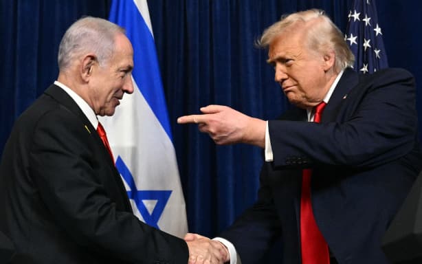 US President Donald Trump (R) and Israeli Prime Minister Benjamin Netanyahu shake hands as they arrive to speak to journalists during a joint press conference at Trump’s Mar-a-Lago residence in Palm Beach, Florida, on December 29, 2025. US President Donald Trump hosted Israeli Prime Minister Benjamin Netanyahu in Florida on December 29 for crucial talks on moving to the next stage of the fragile Gaza truce plan.
The two leaders also discussed Iran, with Trump saying that if Tehran rebuilt its nuclear facilities the United States would "knock them down." (Photo by Jim WATSON / AFP)