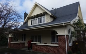 Social workers Charmaine McClean-Whaanga and Rau Sparrow stand outside the new emergency house in Naenae.