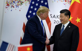 China's President Xi Jinping (R) greets US President Donald Trump before a bilateral meeting on the sidelines of the G20 Summit in Osaka on June 29, 2019.