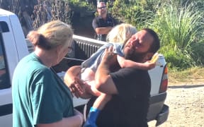 Glenn hugs son Axle after the three-year-old was found following an overnight search