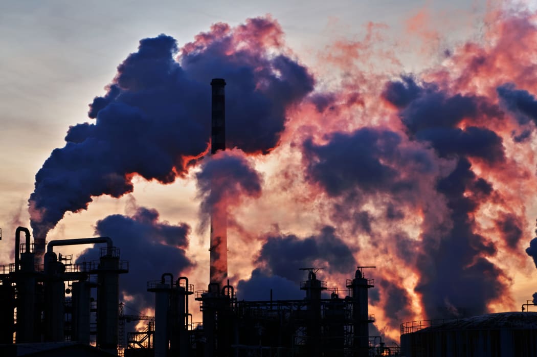 36632031 - chimneys and dark smoke over chemical factory at sunset