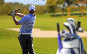 Man playing golf.