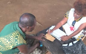 Household registration of people displaced by the Mt Ulawun volcano by PNG Red Cross Society at Bakada