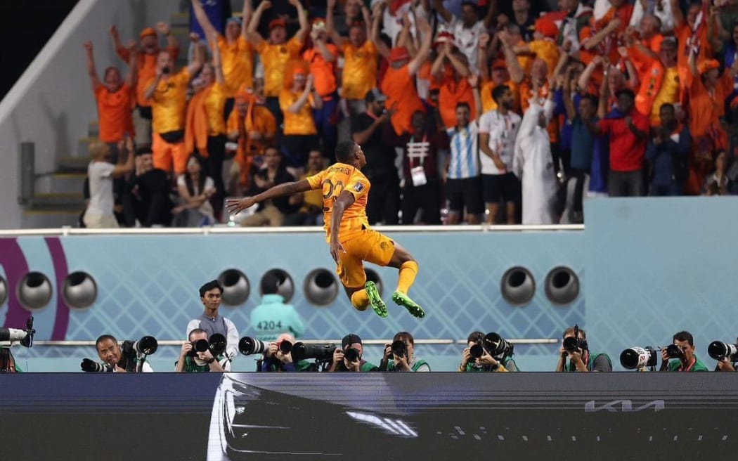 New Zealand ball boy Taha Shameem watches Denzel Dumfries celebrate this goal against the United States.