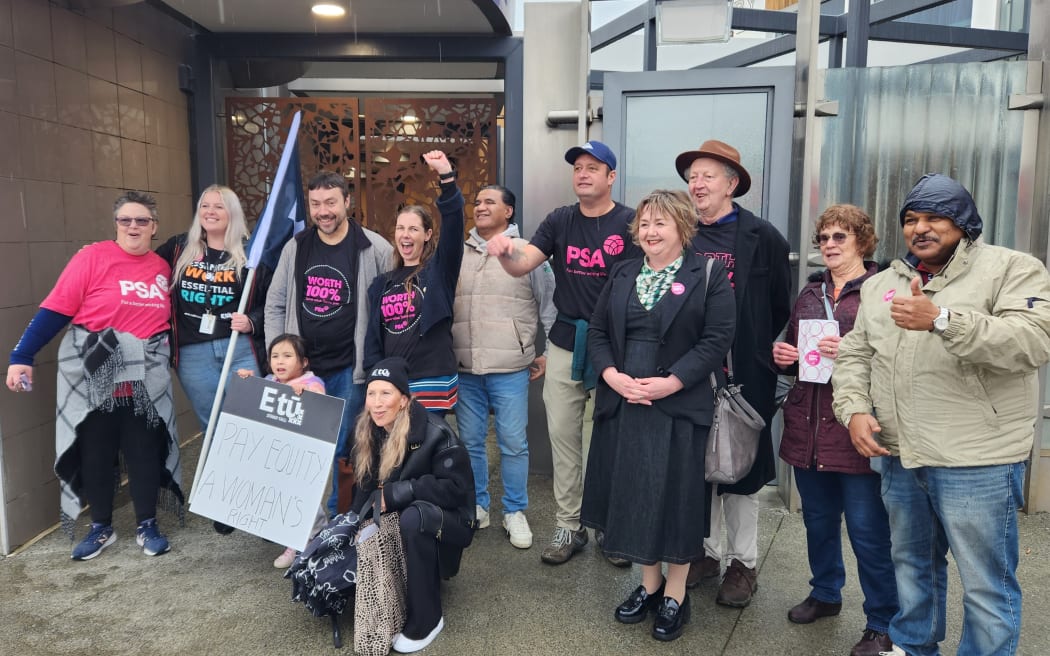 Christchurch care and support workers flank local MP Megan Woods at a rally in Hornby.