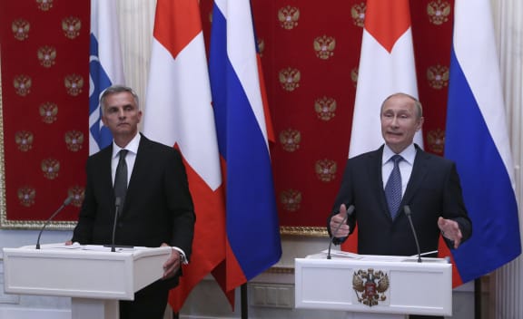 Vladimir Putin and Swiss President Didier Burkhalter (left) at a news conference following talks in Moscow