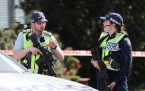 Armed police are seen at the top of Totara Road in Miramar, Wellington, after a person was found dead at a residential property on 16 October, 2023.