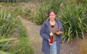 Tyne Nelson in the rongoā garden on Te Mata Peak holding herbal remedies used in traditional Maori healing.