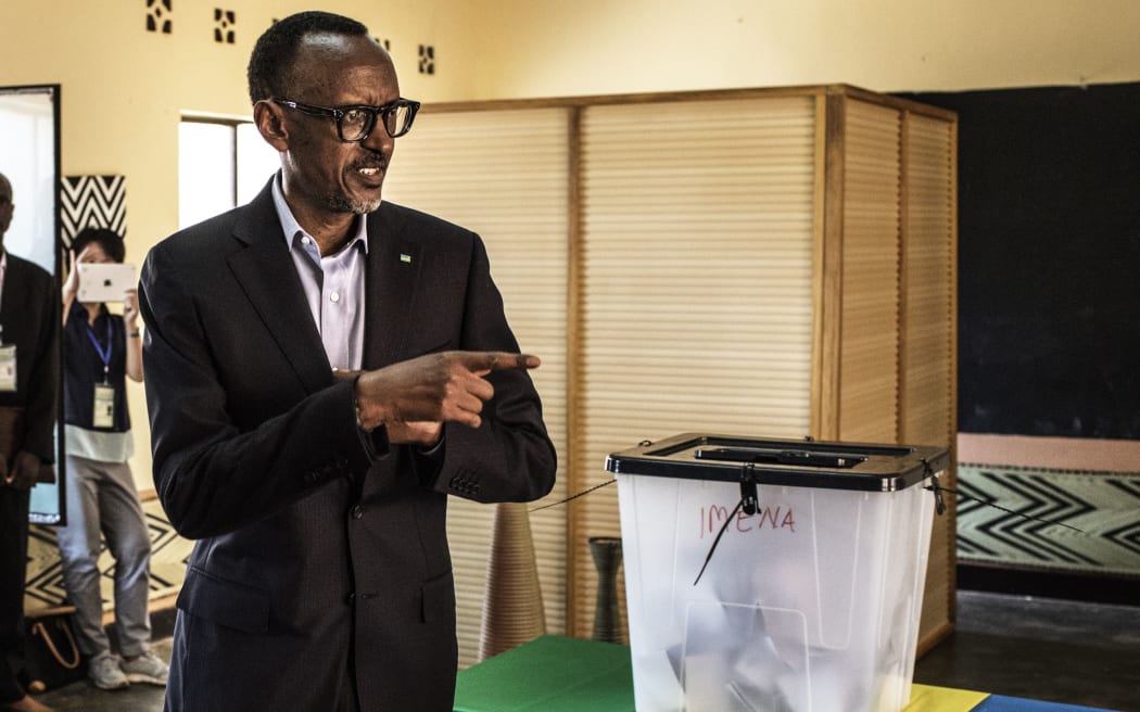 Incumbent Rwandan President Paul Kagame gestures as he arrives to cast his vote at a polling station in Kigali,