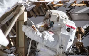 Astronaut Anne McClain working on the International Space Station's Port-4 truss structure during a six-hour, 39-minute spacewalk to upgrade the orbital complex's power storage capacity.