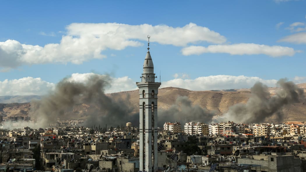 A picture taken on February 27, 2018, shows smoke plumes rising during reported regime bombardment Syrian rebel-held town of Douma, in the besieged Eastern Ghouta region on the outskirts of the capital Damascus.