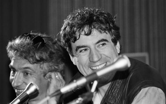 Monty Python star and film director Terry Jones, right, speaks to meda about his film "The Meaning of Life" at the Cannes film festival, 1983.