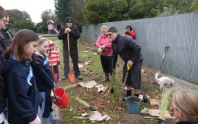 The volunteers gathered for some tips on planting before they get started.