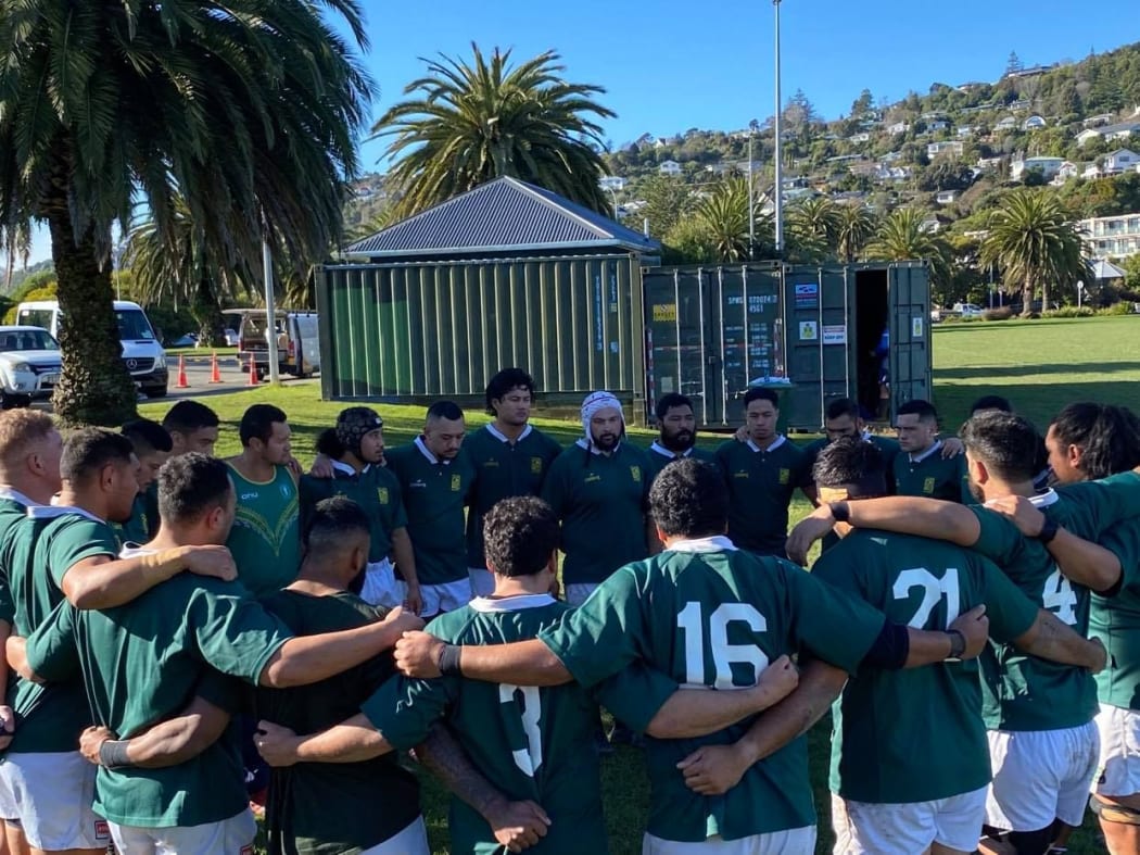 The Cook Islands men's rugby team huddle together before kickoff.