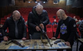 Civilians learn to use AK47 rifles in a cinema at the Lviv Film Center on 5 March 2022 in Lviv, Ukraine.