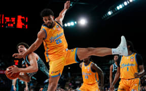 Breakers player Karim Lopez (L) is is met by Brisbane Bullets defender Sam McDaniel.