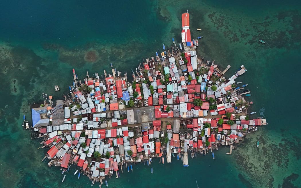 Buildings cover Gardi Sugdub Island, part of San Blas archipelago off Panama's Caribbean coast, Saturday, May 25, 2024. Due to rising sea levels, about 300 Guna Indigenous families will relocate to new homes, built by the government, on the mainland. (AP Photo/Matias Delacroix)