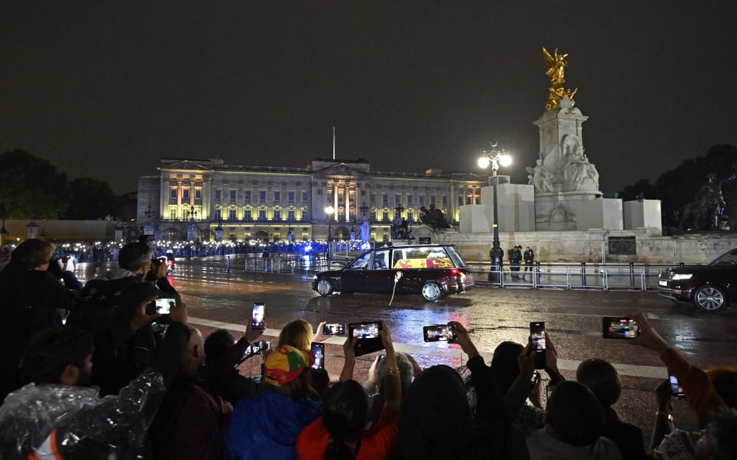 The coffin of Queen Elizabeth II arrives in the Royal Hearse at Buckingham Palace in London, 13 September 2022.