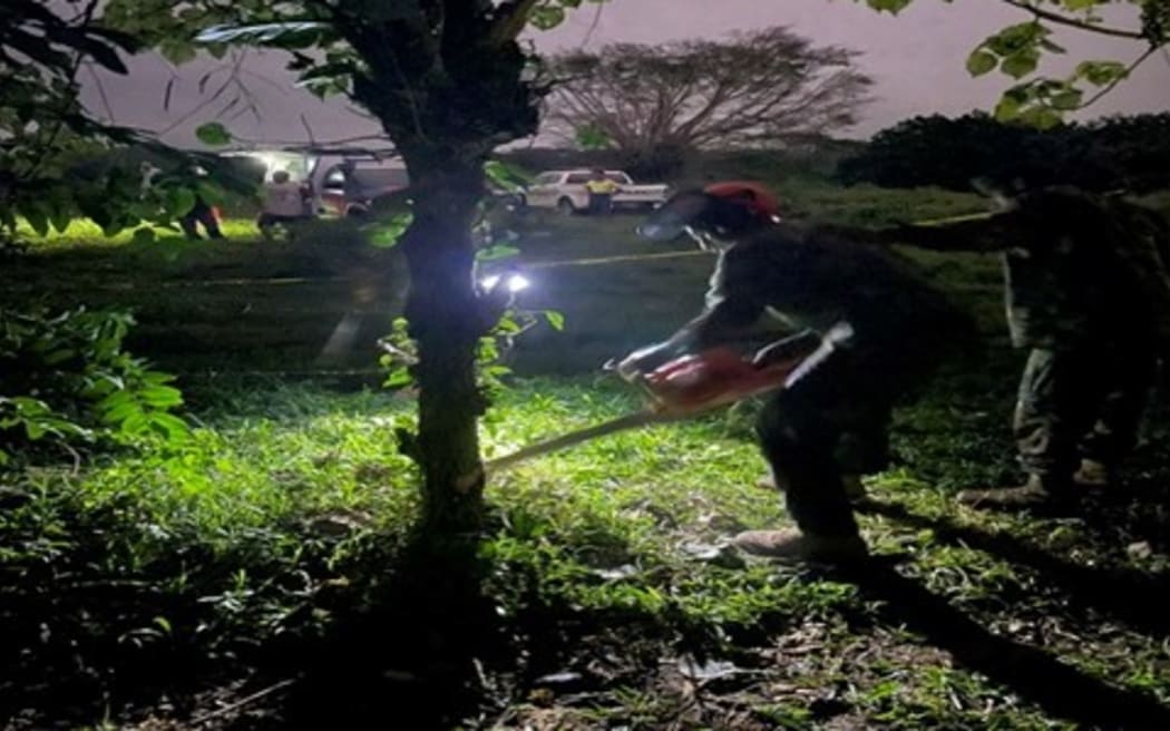 Vanuatu Mobile Force engineers cut through a plantation to allow emergency services to get to a crashed light plane in 2024.
