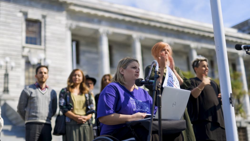 Juliana Carvalho presents a petition to parliament on 23 March, 2021, saying legislation stops her and other people with disabilities from getting residency.