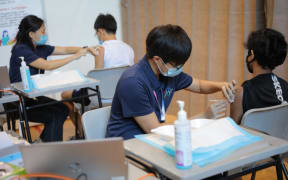 Students getting their vaccinations at the dedicated  Ministry of Education (MOE) vaccination centre at ITE College Central, 7 June 2021.