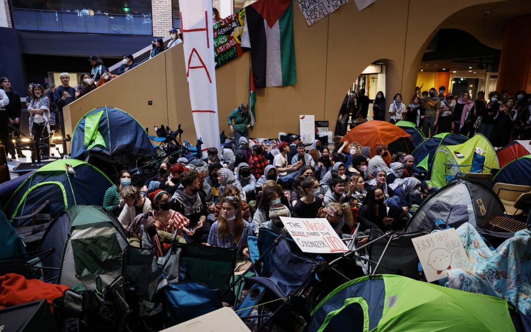 Pro-Palestinian students hold a sit-in in Melbourne on May 15, 2024 at Melbourne University's Arts West building, which the students have temporarily renamed as "Mahmoud's Hall" after Mahmoud Al Haq, a prospective University of Melbourne student, who died in Gaza. (Photo by Martin KEEP / AFP)