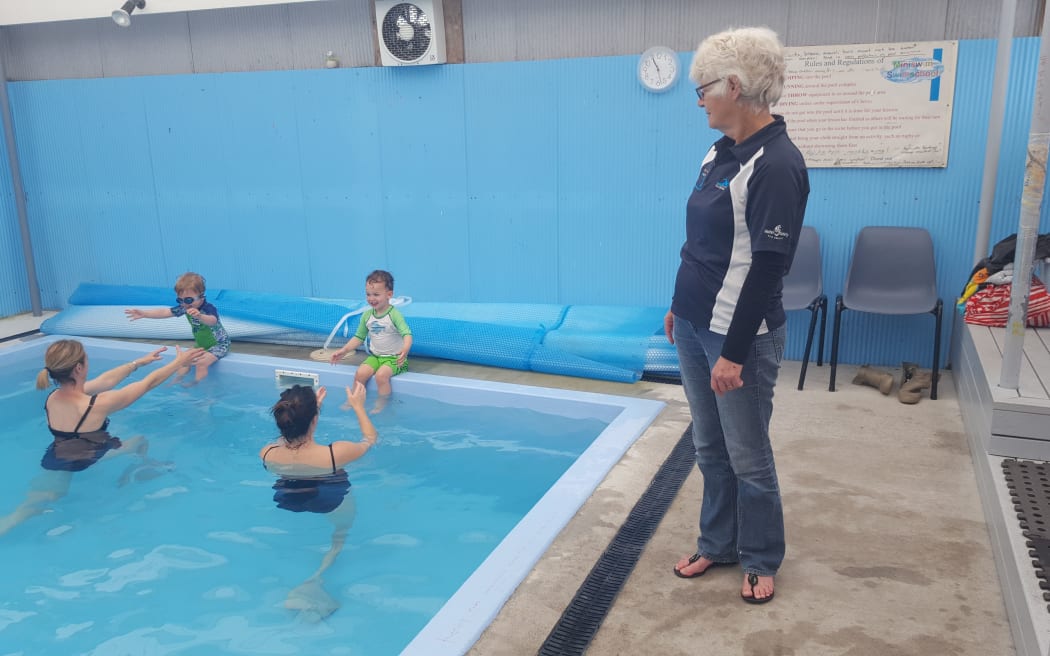 Chrissi Tukaki, the owner of Miniswim, watches a toddler class underway.