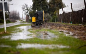 A digger roadside in Brooklyn showing signs of flooding