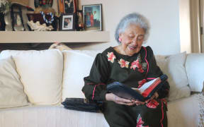 Taesega I E Sidler reading her bible at home