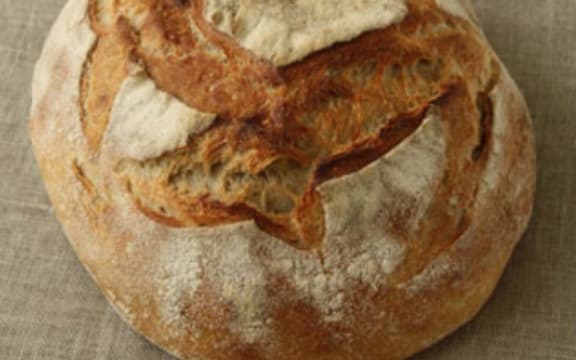 Handmade pain au levain (sourdough) loaf on a hessian cloth