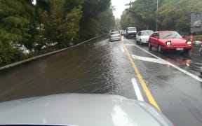 70 - Avonside Drive. Avon River broken banks and spilling onto road.