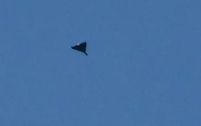 A Russian drone flies during drone and missile strikes in Kyiv on September 7, 2025, amid the Russian invasion of Ukraine. Russia fired its biggest-ever aerial barrage at Ukraine early on September 7, setting the seat of the Ukrainian government in Kyiv ablaze, authorities said. (Photo by Genya SAVILOV / AFP)